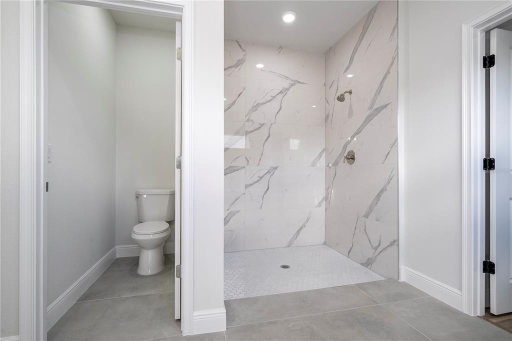 3970 Southwest 157th Place Road Ocala, FL 34473 - Photo 84 of 87 a bathroom with a granite countertop shower and a toilet