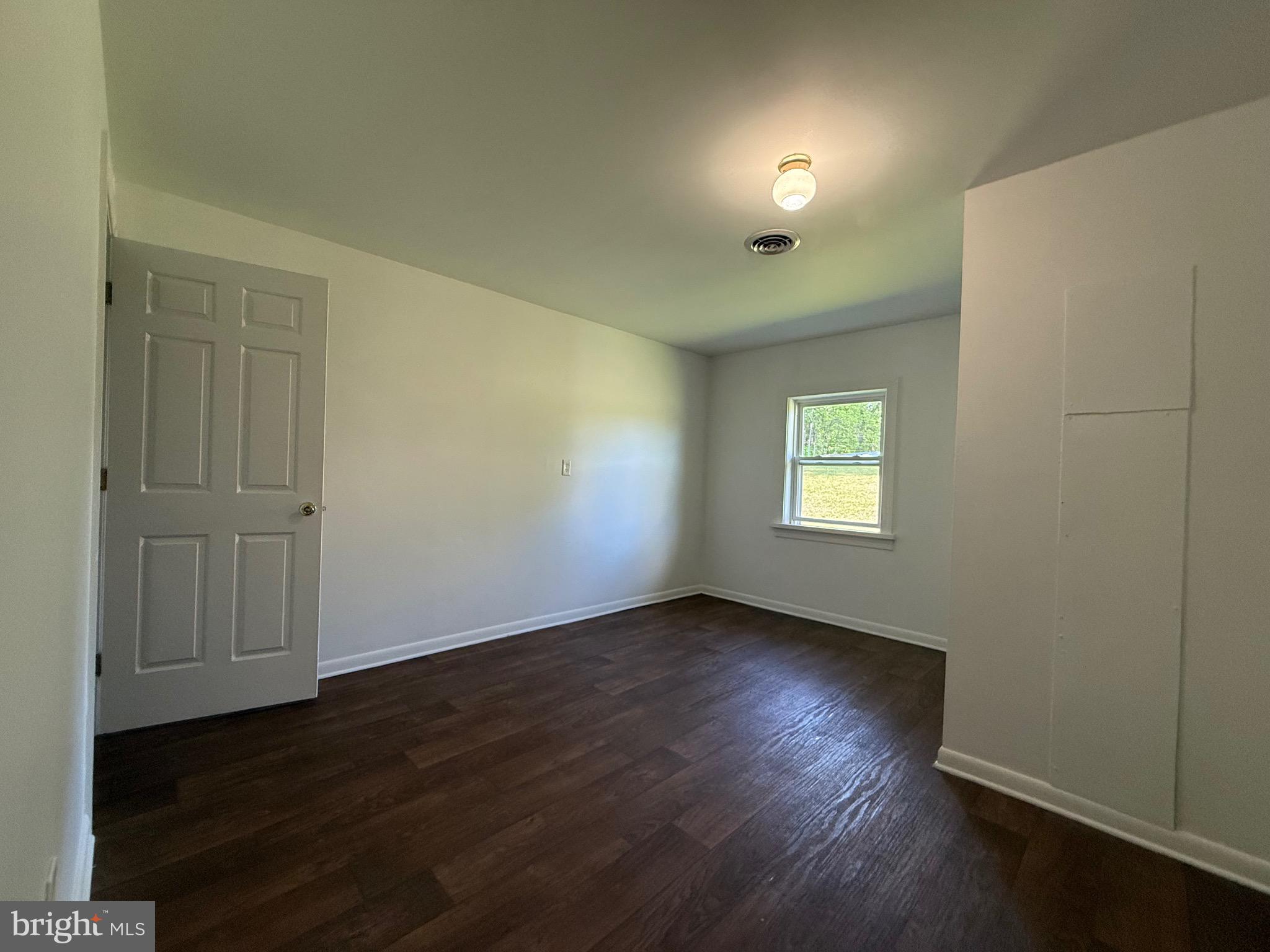2315 Oak Park Road, Unit B Madison, VA 22727 - Photo 6 of 7 an empty room with wooden floor and windows