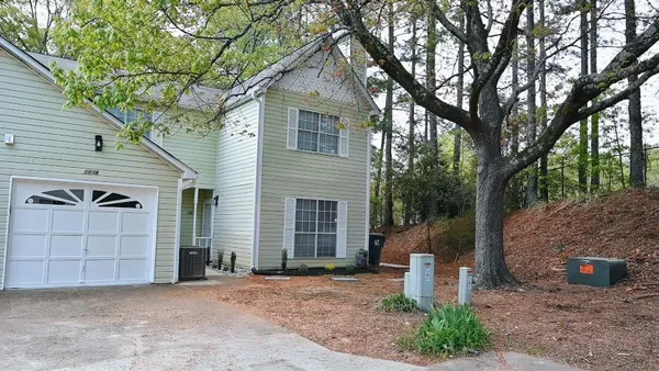 a front view of a house with a yard and garage