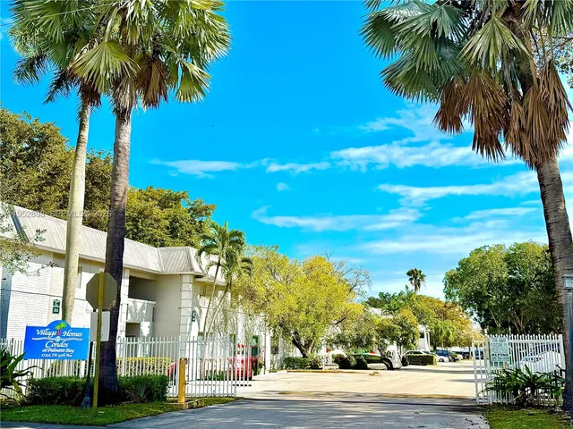 a view of a palm trees in front of a building