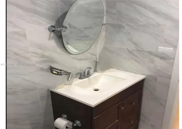 a bathroom with a sink mirror and vanity
