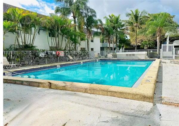 a view of swimming pool with a garden and trees