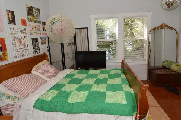 a bed room with a bed and a window