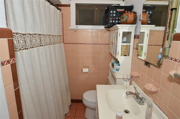 a large bed sitting in a bedroom next to a window