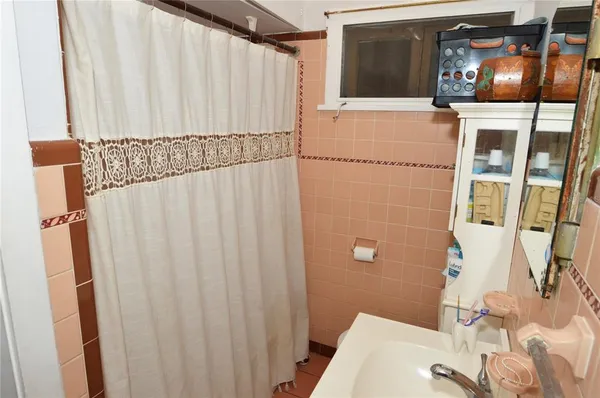 a room with a refrigerator and a window