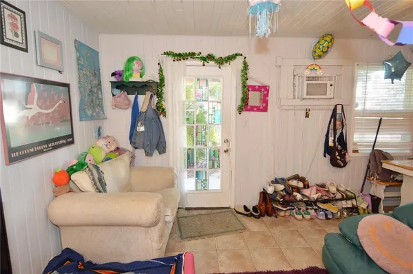 a view of a house with backyard porch and sitting area