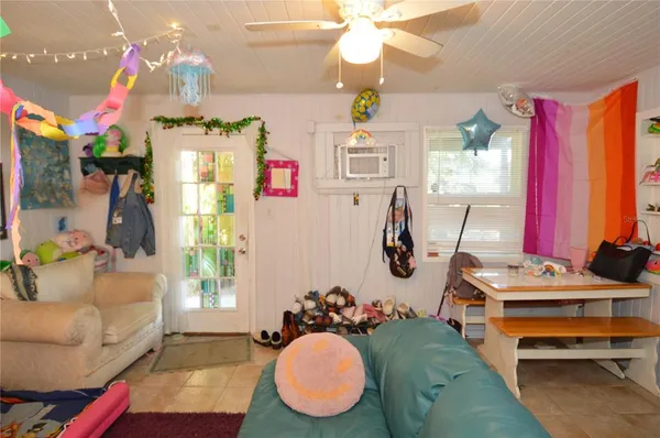 a view of a livingroom with furniture and a window