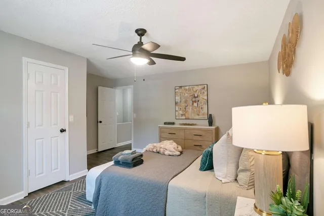 a bedroom with a bed and a lamp