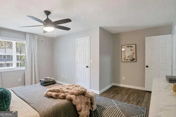 a bedroom with a large bed and a window