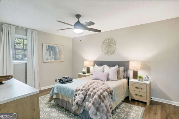 a bedroom with a bed and wooden floor