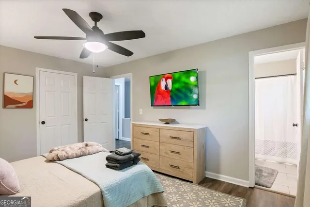 a bedroom with a bed and a flat screen tv