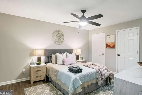 a bedroom with a large bed and a chandelier