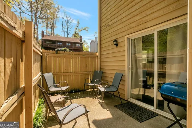 a view of a patio with table and chairs and wooden floor