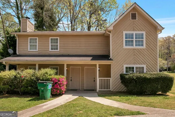 a front view of a house with a garden