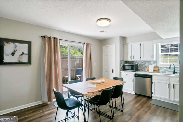 a kitchen with a table and chairs in it