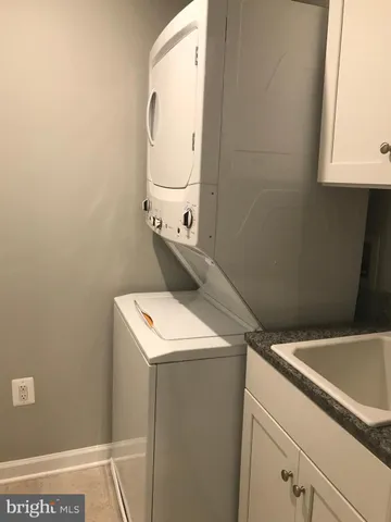 a bathroom with a granite countertop sink a toilet and mirror