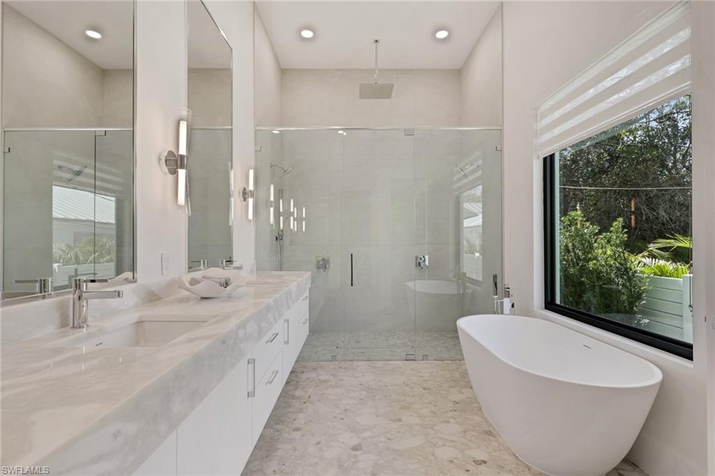 1150 8th Terrace North Naples, FL 34102 - Photo 22 of 39 Full bath with a freestanding bath, a shower stall, double vanity, and recessed lighting