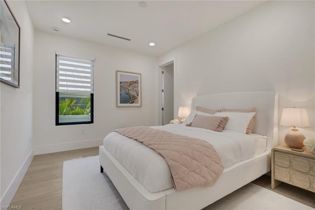 1150 8th Terrace North Naples, FL 34102 - Photo 26 of 39 Bedroom with light wood finished floors and recessed lighting