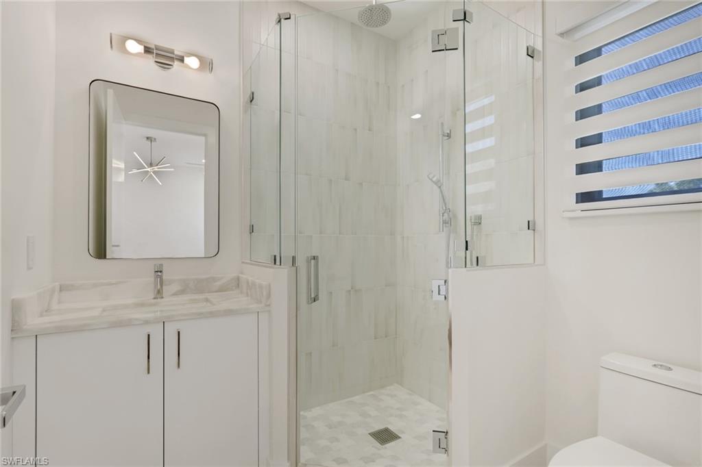 1150 8th Terrace North Naples, FL 34102 - Photo 36 of 39 Full bathroom featuring vanity and a stall shower