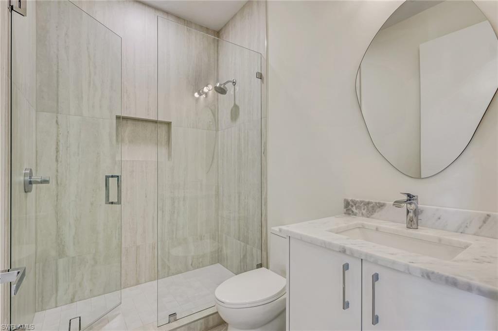 1150 8th Terrace North Naples, FL 34102 - Photo 39 of 39 Bathroom featuring vanity and a stall shower