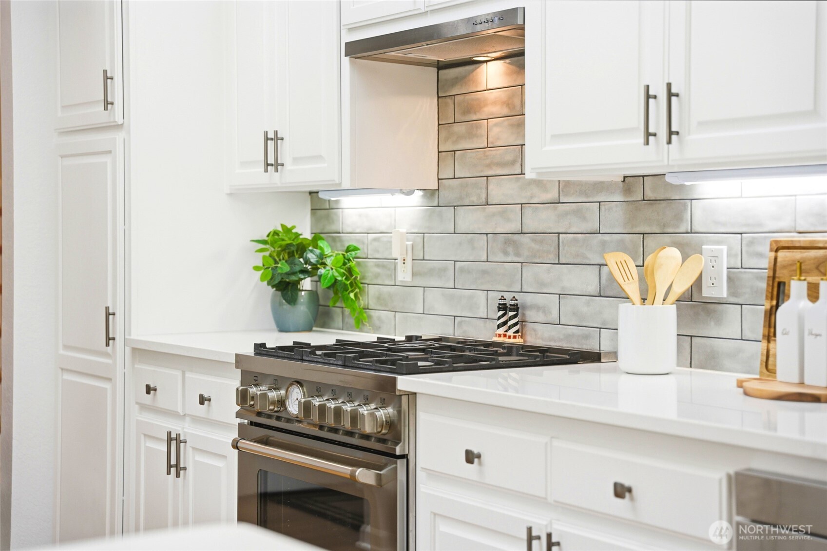 8910 56th Place West Mukilteo, WA 98275 - Photo 11 of 40 a kitchen with granite countertop a stove and a sink