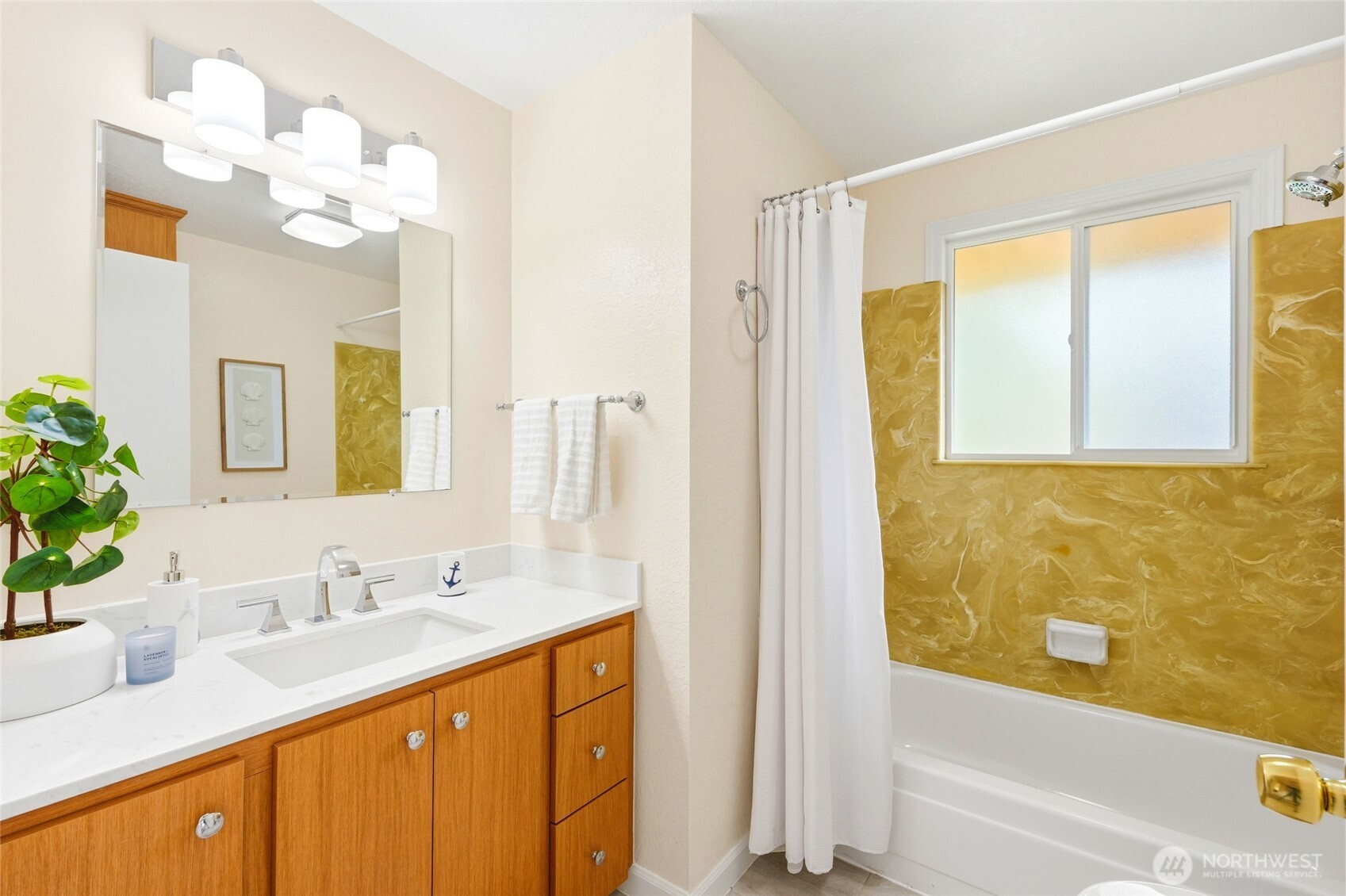 8910 56th Place West Mukilteo, WA 98275 - Photo 20 of 40 a bathroom with a granite countertop sink a large mirror and a bathtub