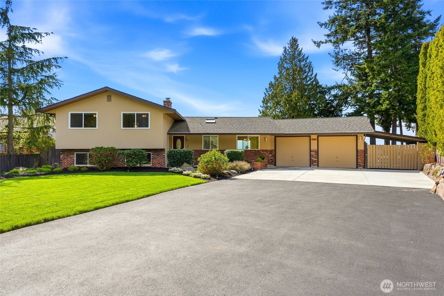 8910 56th Place West Mukilteo, WA 98275 - Photo 2 of 40 a front view of a house with a yard and garage
