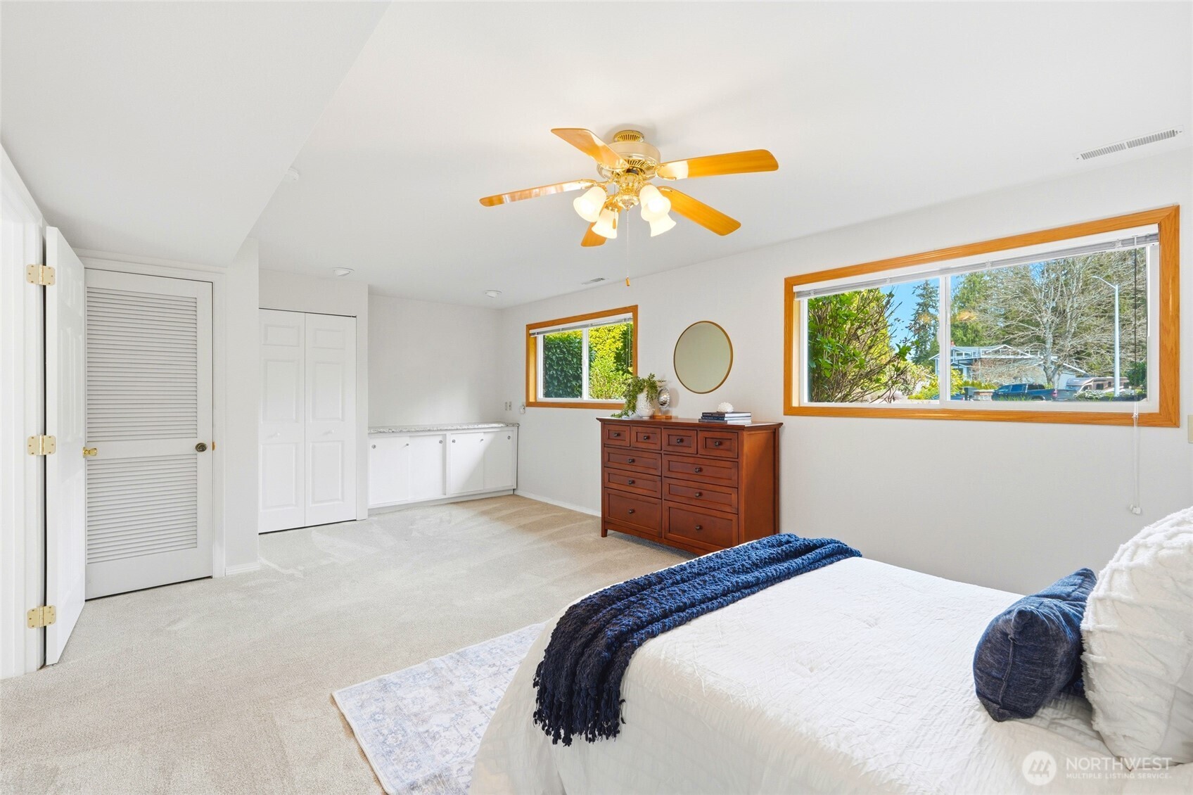 8910 56th Place West Mukilteo, WA 98275 - Photo 26 of 40 a bedroom with a bed and a chandelier