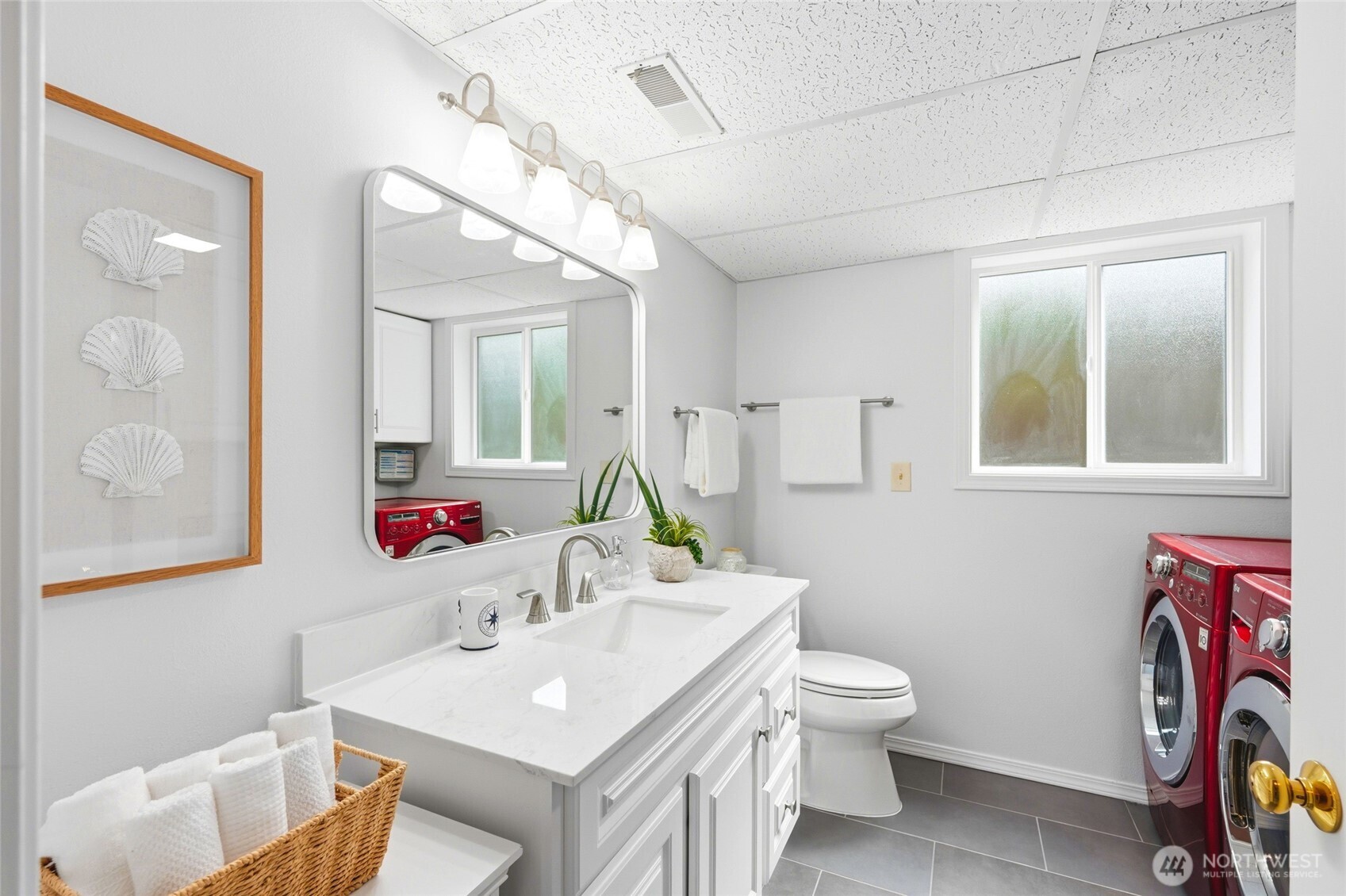 8910 56th Place West Mukilteo, WA 98275 - Photo 27 of 40 a bathroom with a sink vanity mirror and toilet