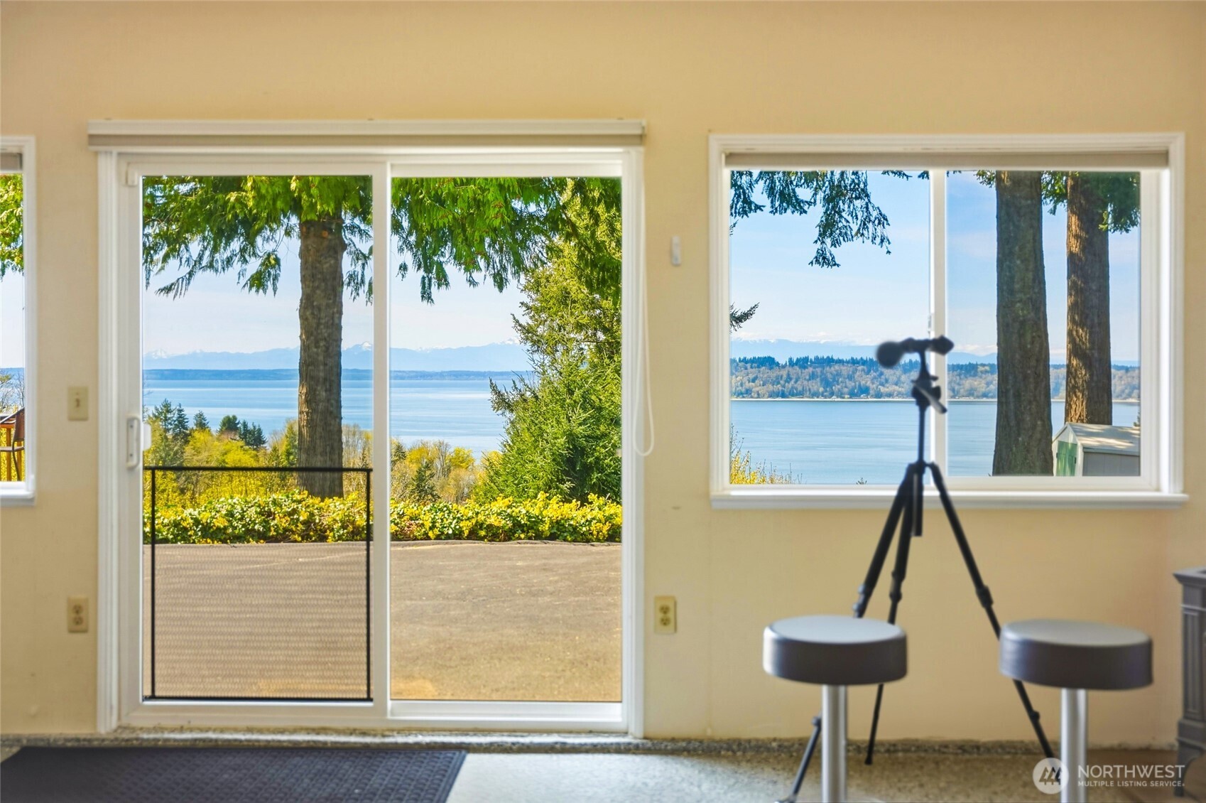 8910 56th Place West Mukilteo, WA 98275 - Photo 30 of 40 a view of a living room with a floor to ceiling window and wooden floor