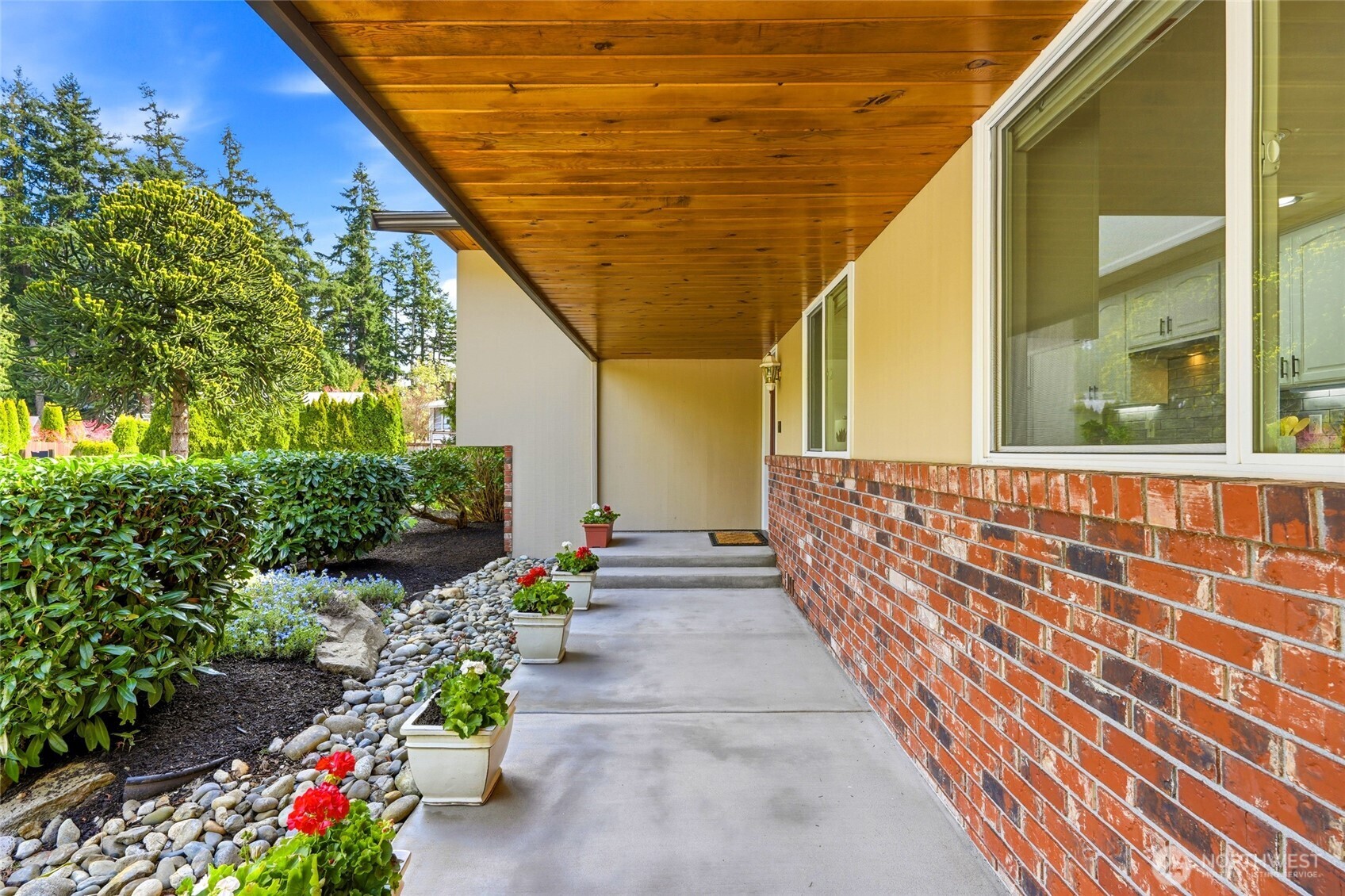 8910 56th Place West Mukilteo, WA 98275 - Photo 4 of 40 a balcony with beautiful flowers and wooden floor
