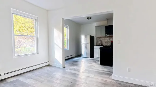a view of a kitchen with a sink and a window
