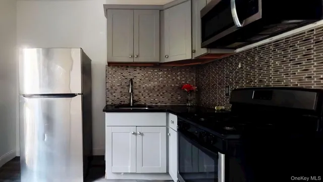 a kitchen with a refrigerator and cabinets