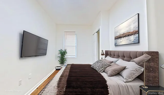 a bed room with a bed window and a flat screen tv