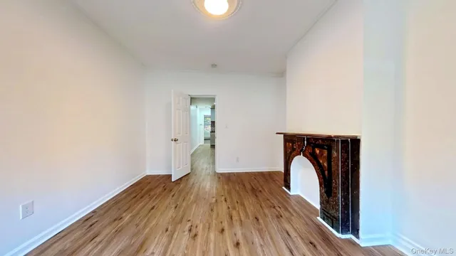 a utility room with wooden floor and a window
