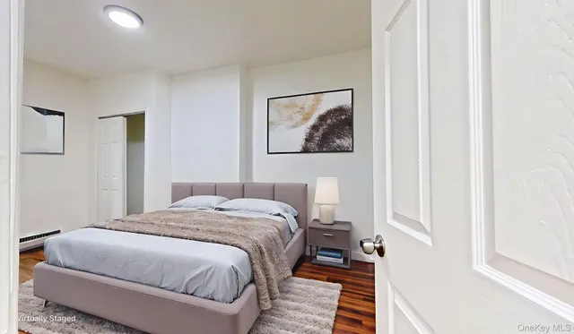 a bedroom with a bed and a painting on the wall