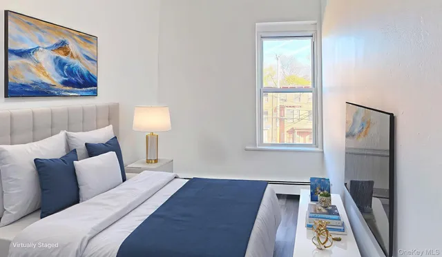 a bed room with a bed and a painting on the wall