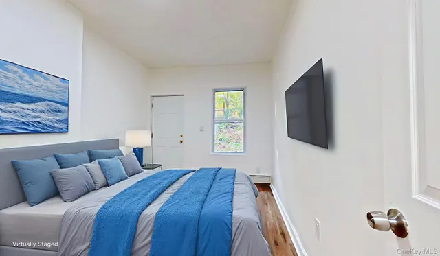 a bedroom with a bed and a flat screen tv