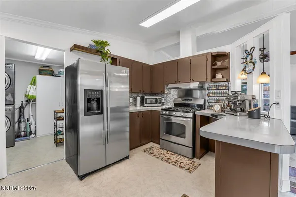 a kitchen with granite countertop a sink appliances and cabinets