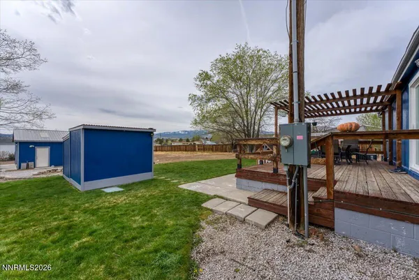 a view of wooden fence and trees around