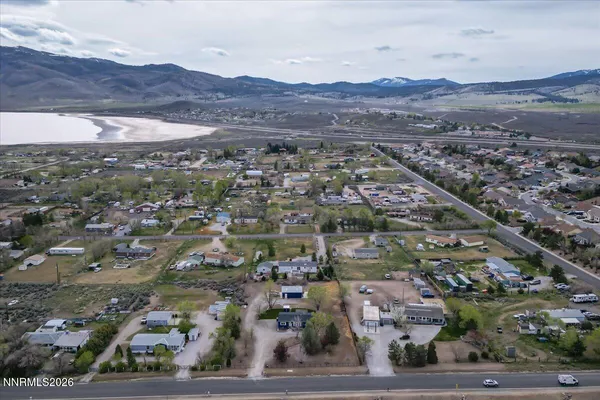 an aerial view of residential house and sandy dunes