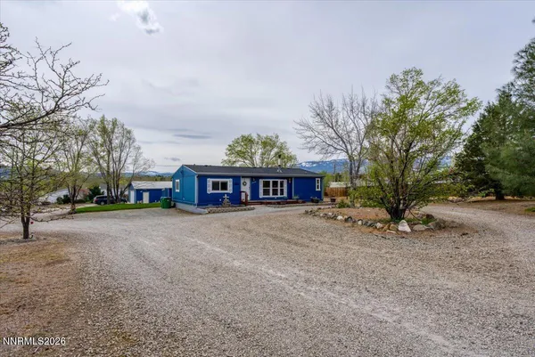 a view of a house with a yard covered in snow