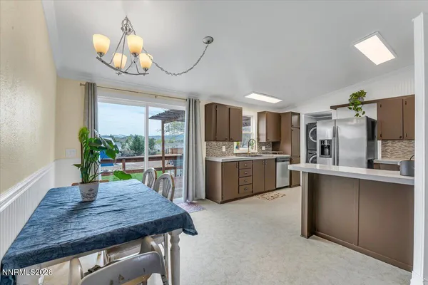 a kitchen with stainless steel appliances granite countertop a refrigerator a stove and a sink