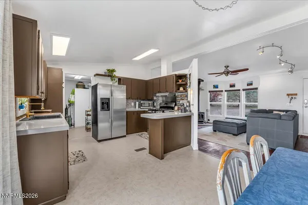 a kitchen with stainless steel appliances a refrigerator sink and stove