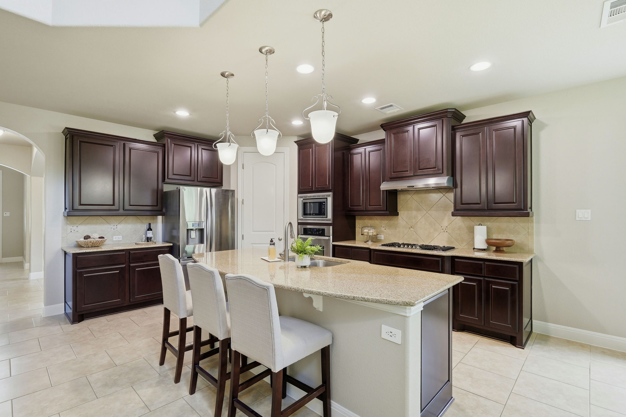110 Dasher Drive Cedar Park, TX 78613 - Photo 10 of 39 An inviting kitchen with a granite island for casual dining, rich cabinetry, and modern appliances.