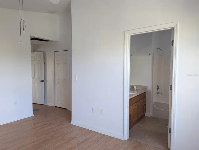an empty room with wooden floor and closet