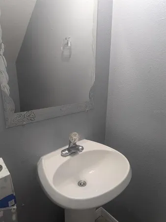 a bathroom with a sink and mirror