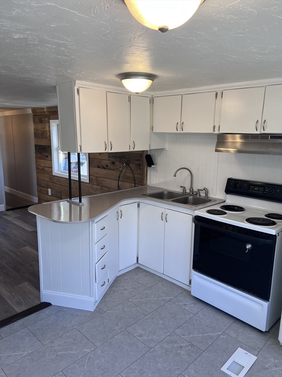 1032 North Main Street, Unit 7 Killingly, CT 06241 - Photo 7 of 9 a kitchen with stainless steel appliances granite countertop a sink and cabinets
