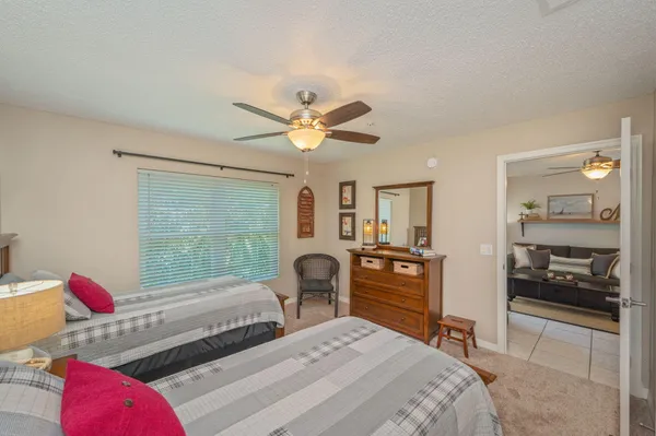 a bedroom with two beds and a large mirror