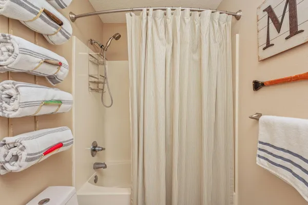 a bathroom with a shower curtain and a curtain